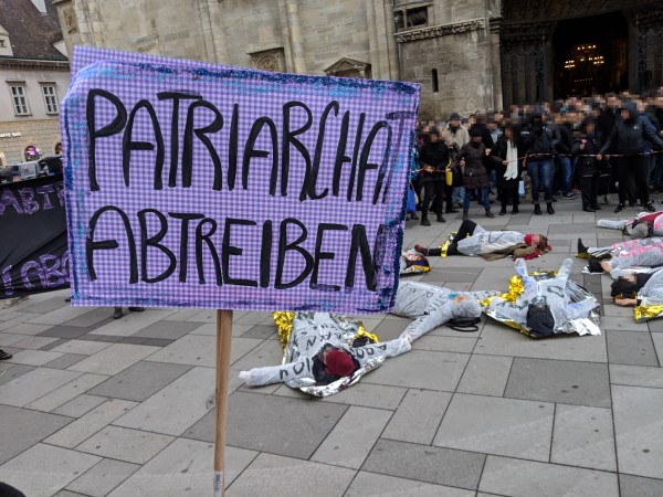 Foto: Patriarchat abtreiben Schild im Vordergrund des Stephansdoms